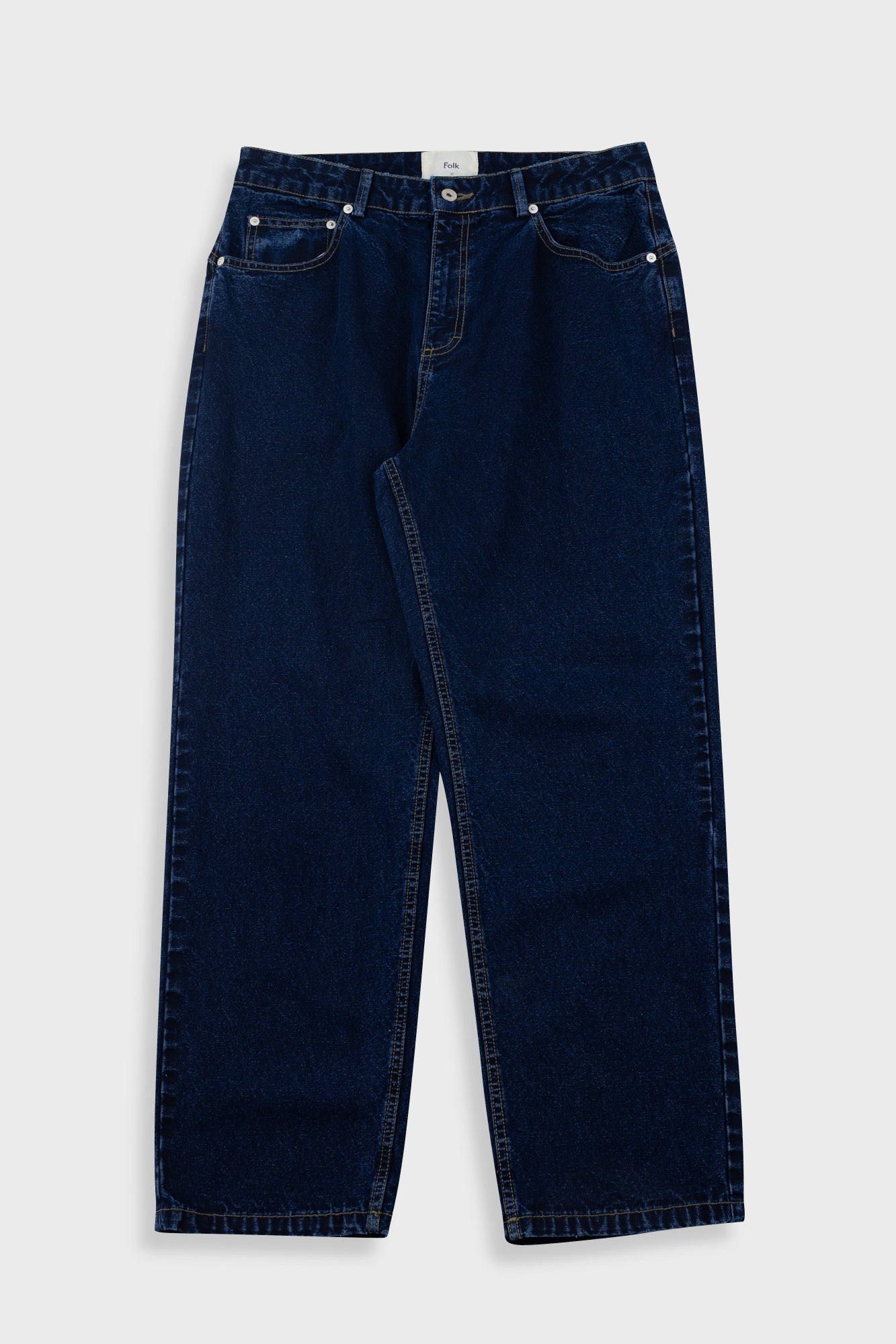 Pair of dark blue jeans on a light gray background