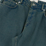 Close-up of green denim jeans with a brand label on a white background
