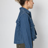 Person wearing a blue striped jacket on a white background