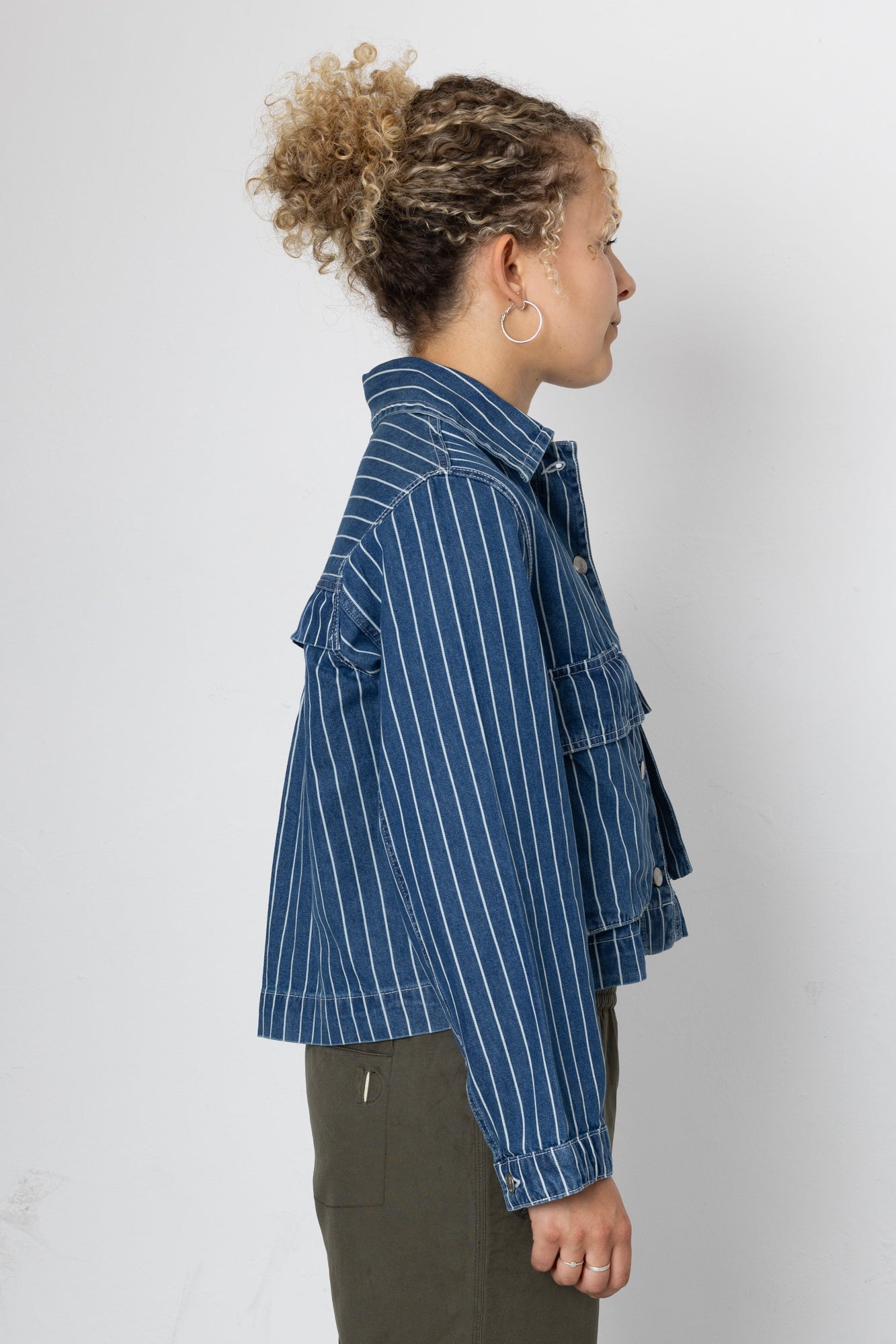 Person wearing a blue striped jacket on a white background