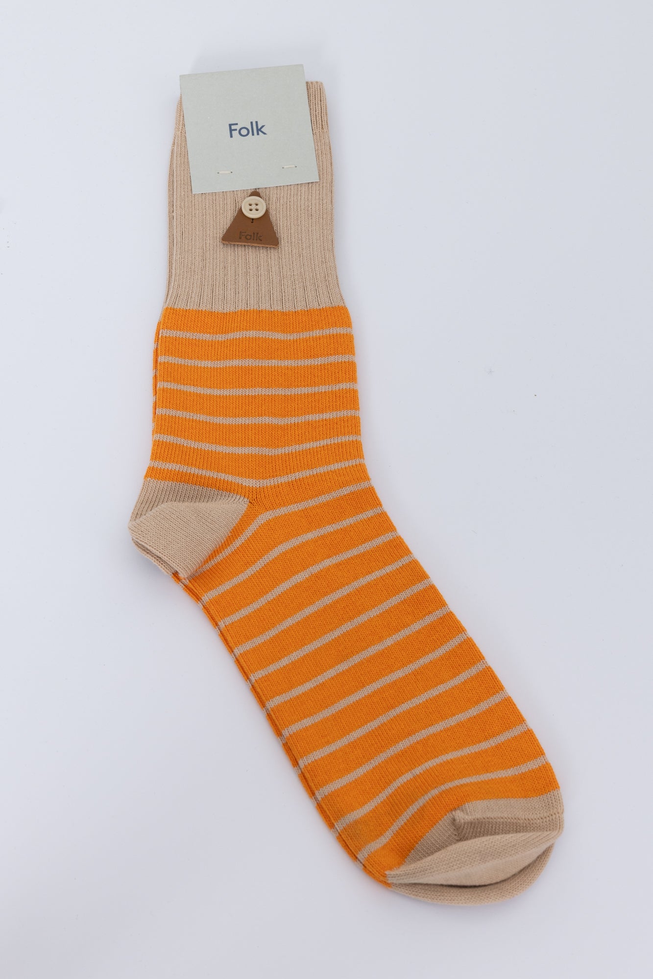 Orange striped sock against a grey background