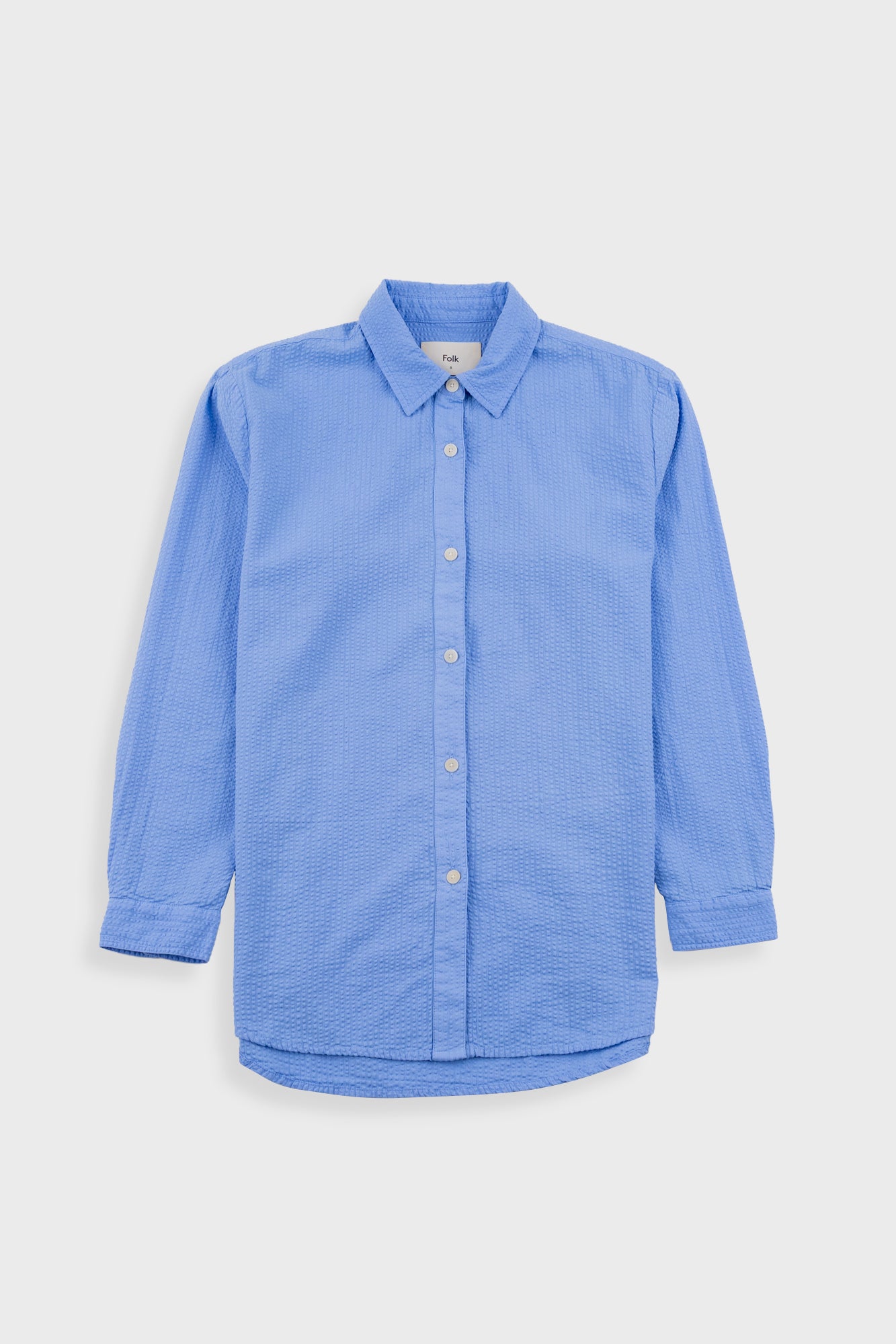 Blue button-up shirt on a light gray background