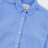 Blue textured shirt with collar and buttons on a white background