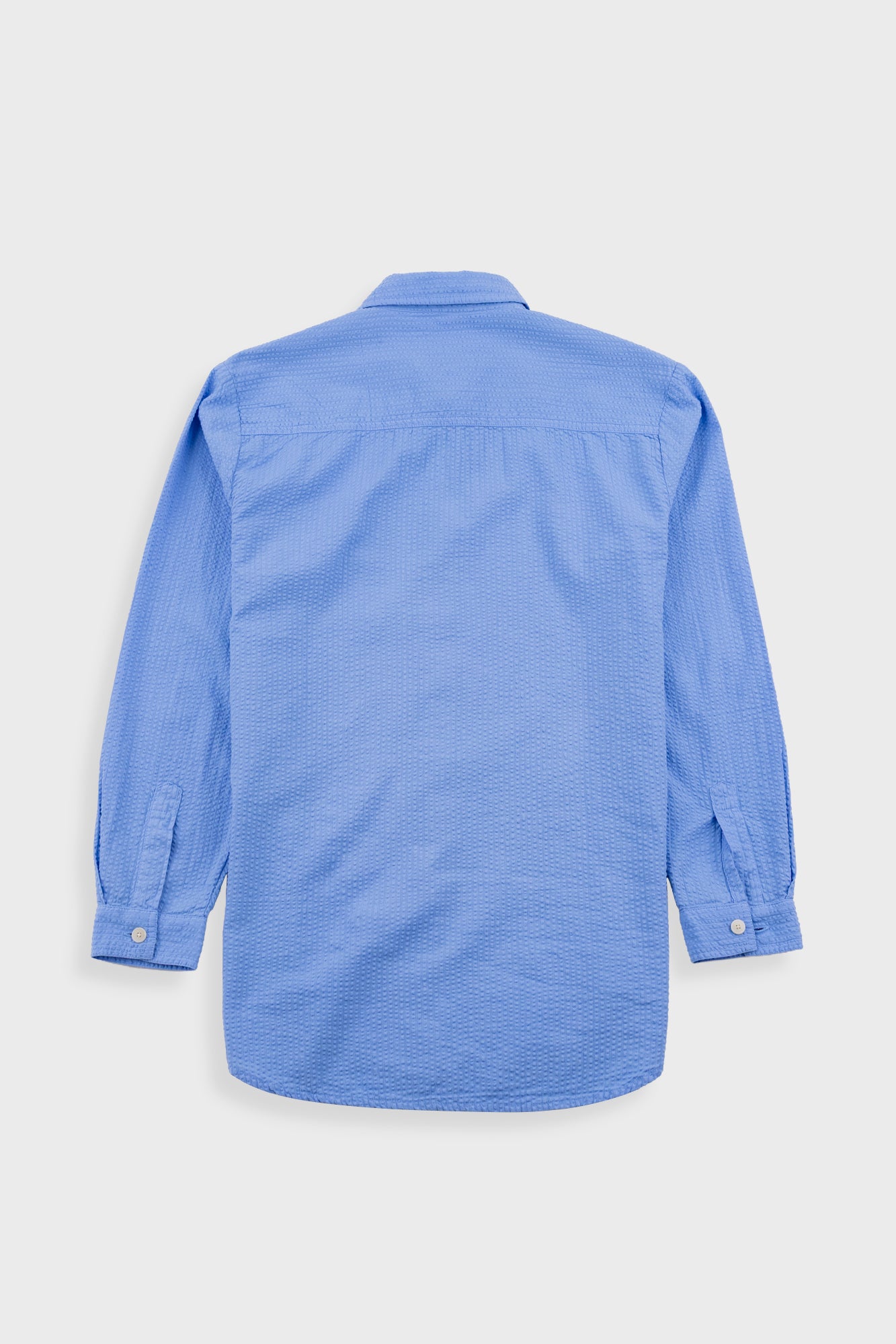 Blue shirt on a light gray background
