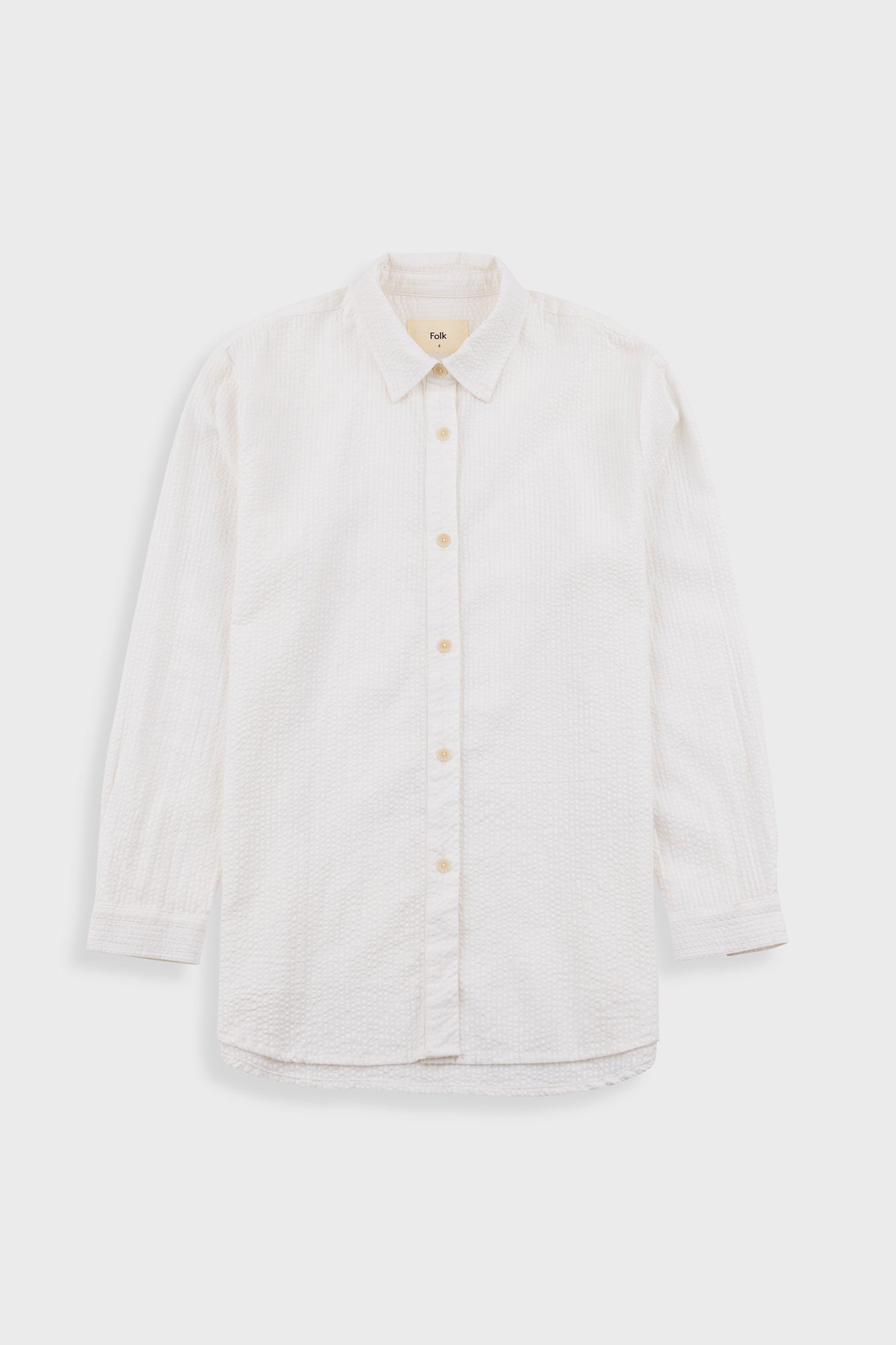 White button-up shirt on a light gray background