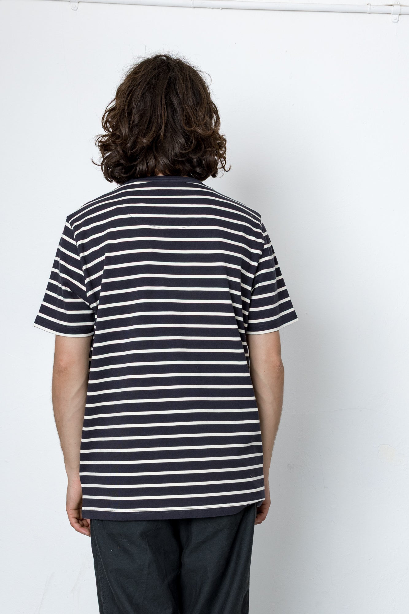 Person wearing a striped shirt against a white background