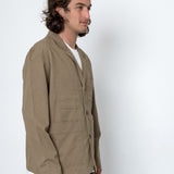 Man wearing a beige jacket against a white background