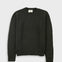 A dark olive green knitted sweatshirt against a light grey background.