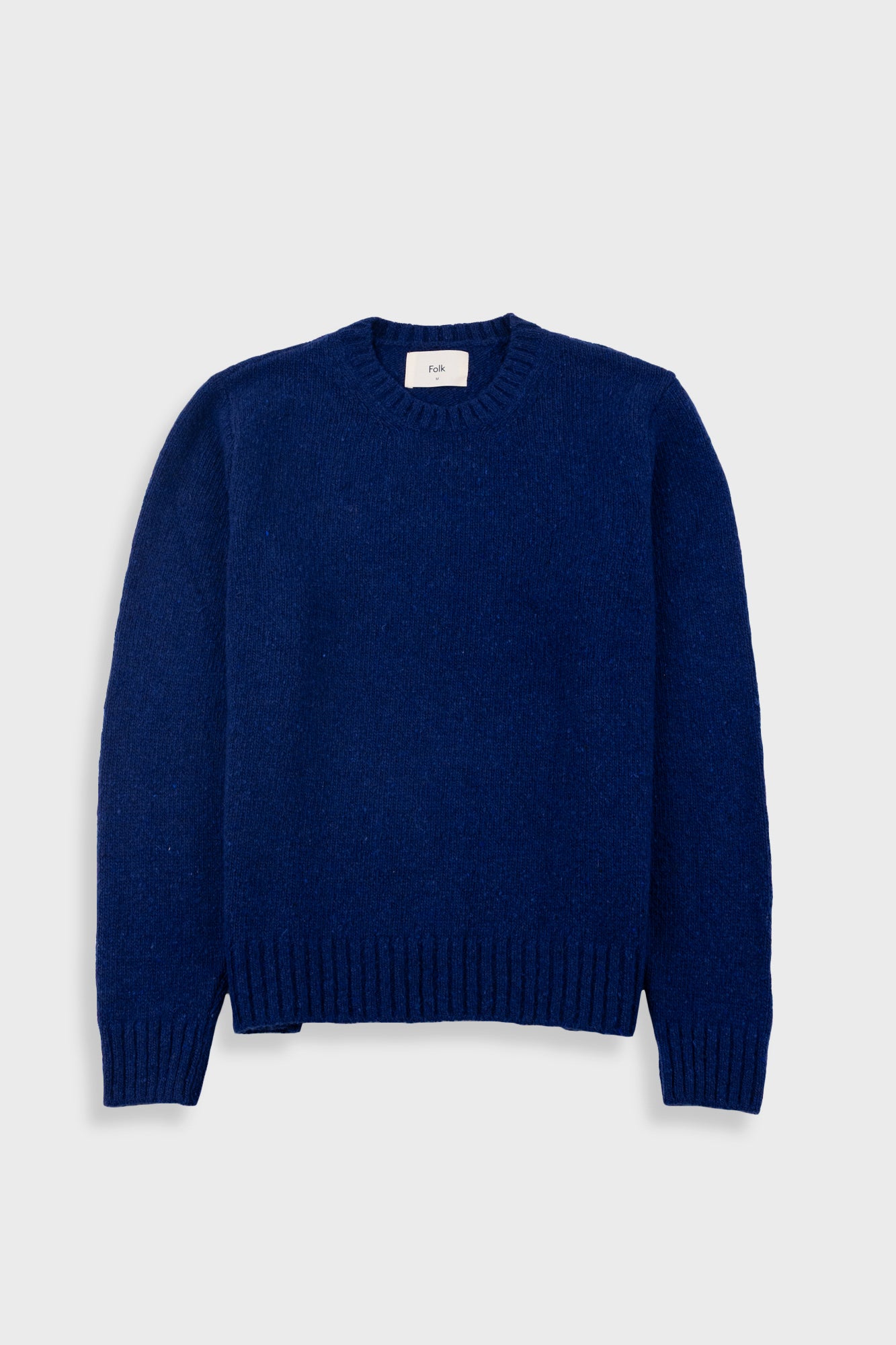 Blue sweater on a light gray background