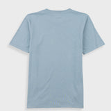 Close-up of a light blue crewneck t-shirt with a white neck label reading 'Folk'.