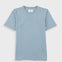 Close-up of a light blue crewneck t-shirt with a white neck label reading 'Folk'.