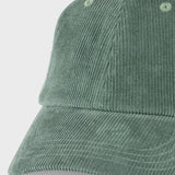 A close-up of a sage green corduroy baseball cap on a light gray background.