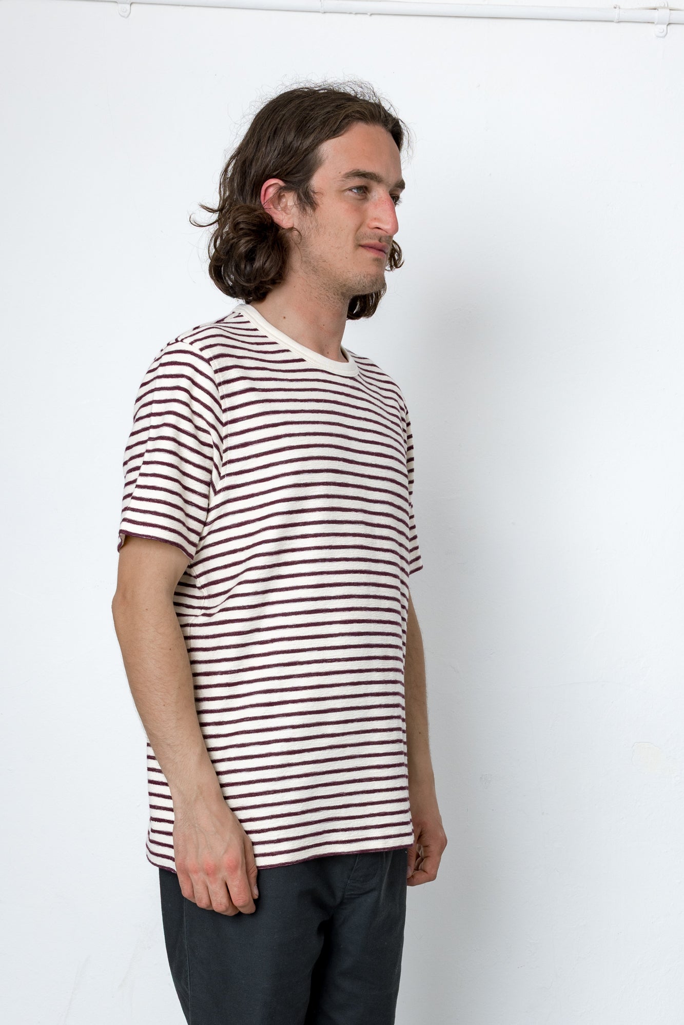 Man wearing a striped shirt against a white background