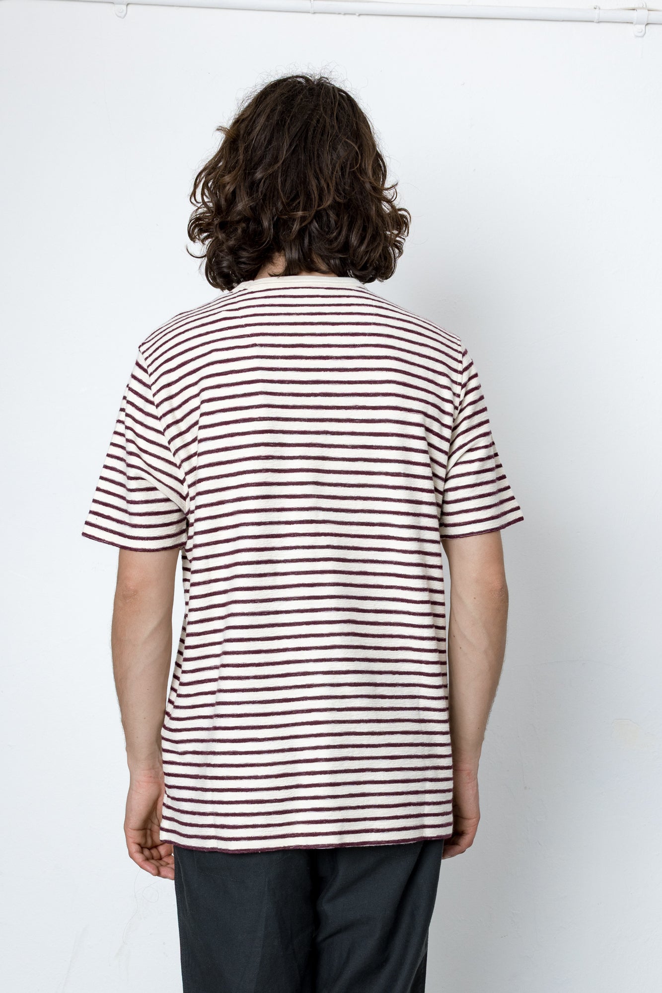 Person wearing a striped shirt against a white background