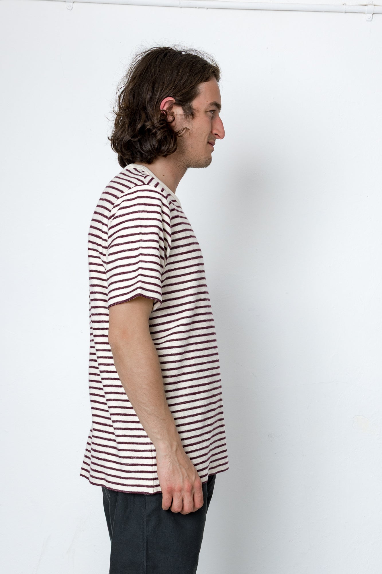 Man wearing a striped t-shirt against a white background