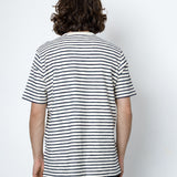 Person wearing a black and white striped shirt against a white background