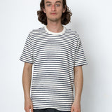 Person wearing a black and white striped t-shirt against a plain background
