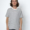 Person wearing a black and white striped t-shirt against a plain background