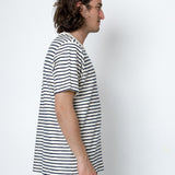 Man wearing a black and white striped t-shirt against a white background