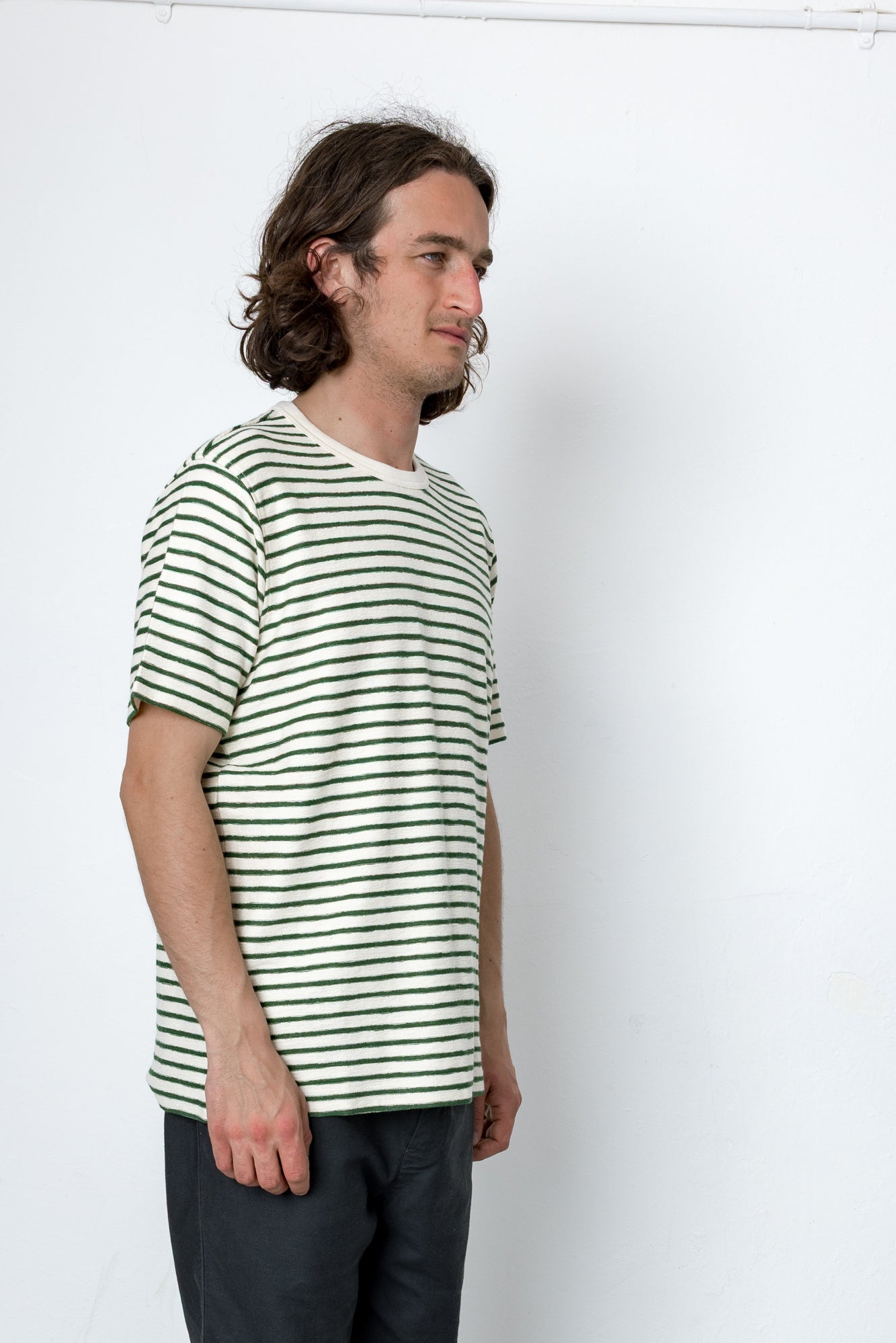 Man wearing a striped shirt against a white background