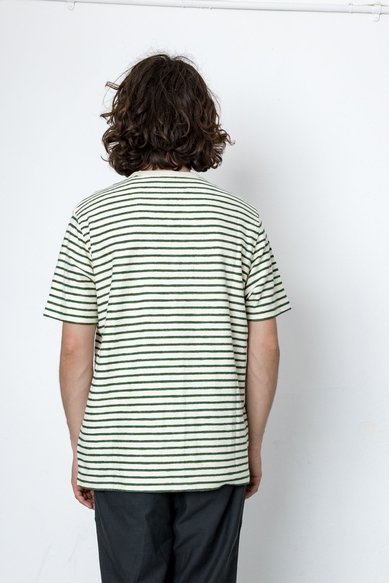 Person wearing a striped shirt against a white background