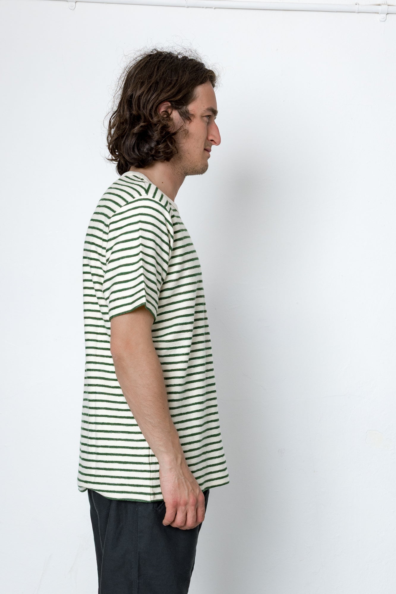 Man wearing a striped shirt against a white background