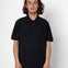 Man wearing a black short-sleeve shirt against a white background