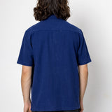 Person wearing a blue shirt against a white background