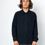 Man wearing a black button-up shirt against a white background
