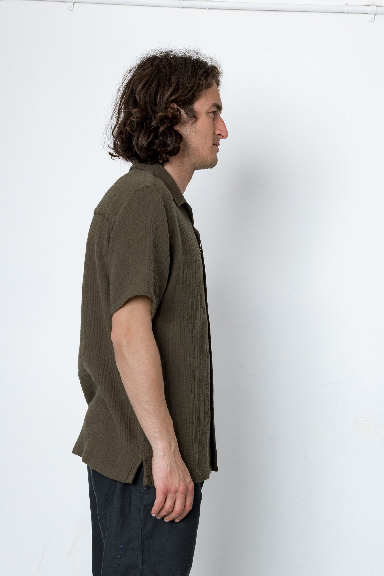 Man wearing a green shirt against a white background