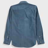 A slate blue long-sleeve button-down shirt shown from the back, featuring a central seam and button cuffs, displayed on a light gray background.