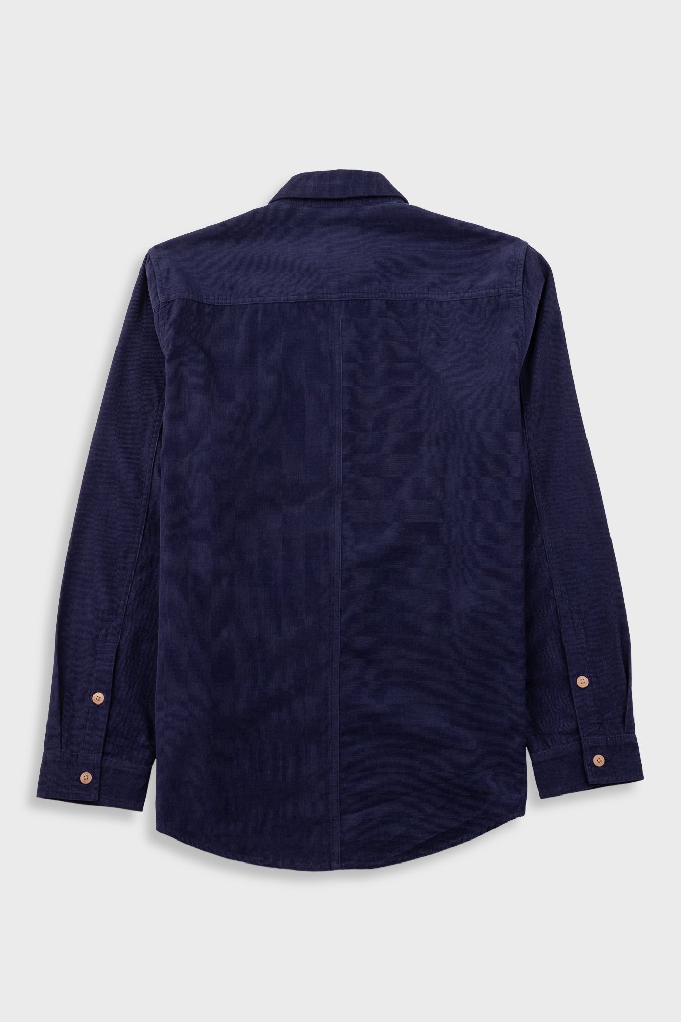 A dark navy blue long-sleeve button-up shirt shown from the back, featuring a subtle corduroy texture and copper-toned buttons on the cuffs, set against a light gray background.