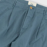 Blue pants with a visible brand label on a light gray background