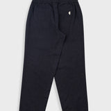 Dark navy blue jogger pants with an elastic waistband and a small white embroidered logo on the left hip, shown flat against a light gray background.