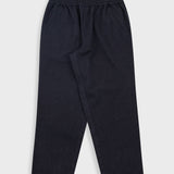 A pair of dark navy blue jogger pants with an elastic waistband, laid flat against a light gray background.