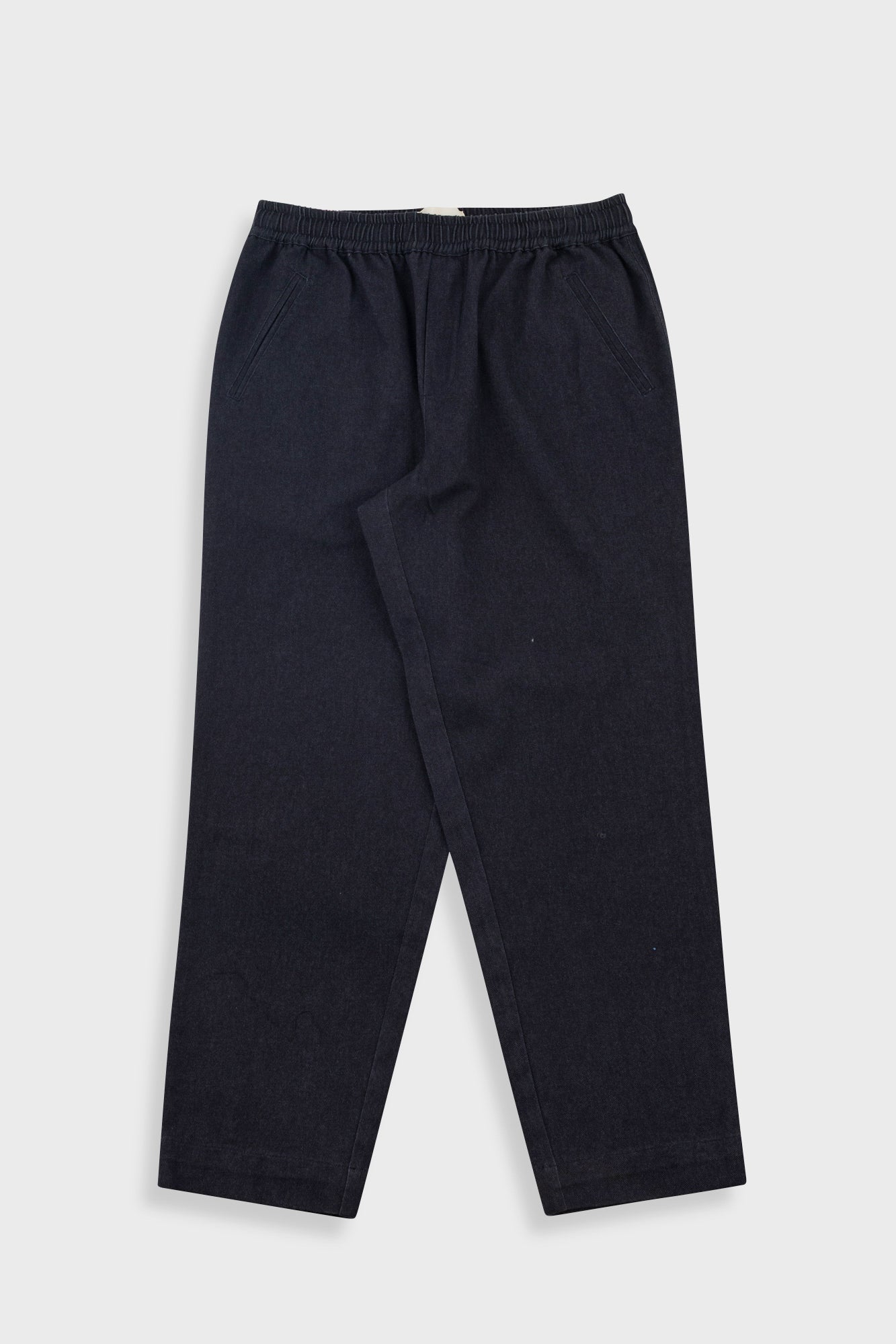 A pair of dark navy blue jogger pants with an elastic waistband, laid flat against a light gray background.