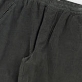 Dark gray pants with an elastic waistband on a light gray background