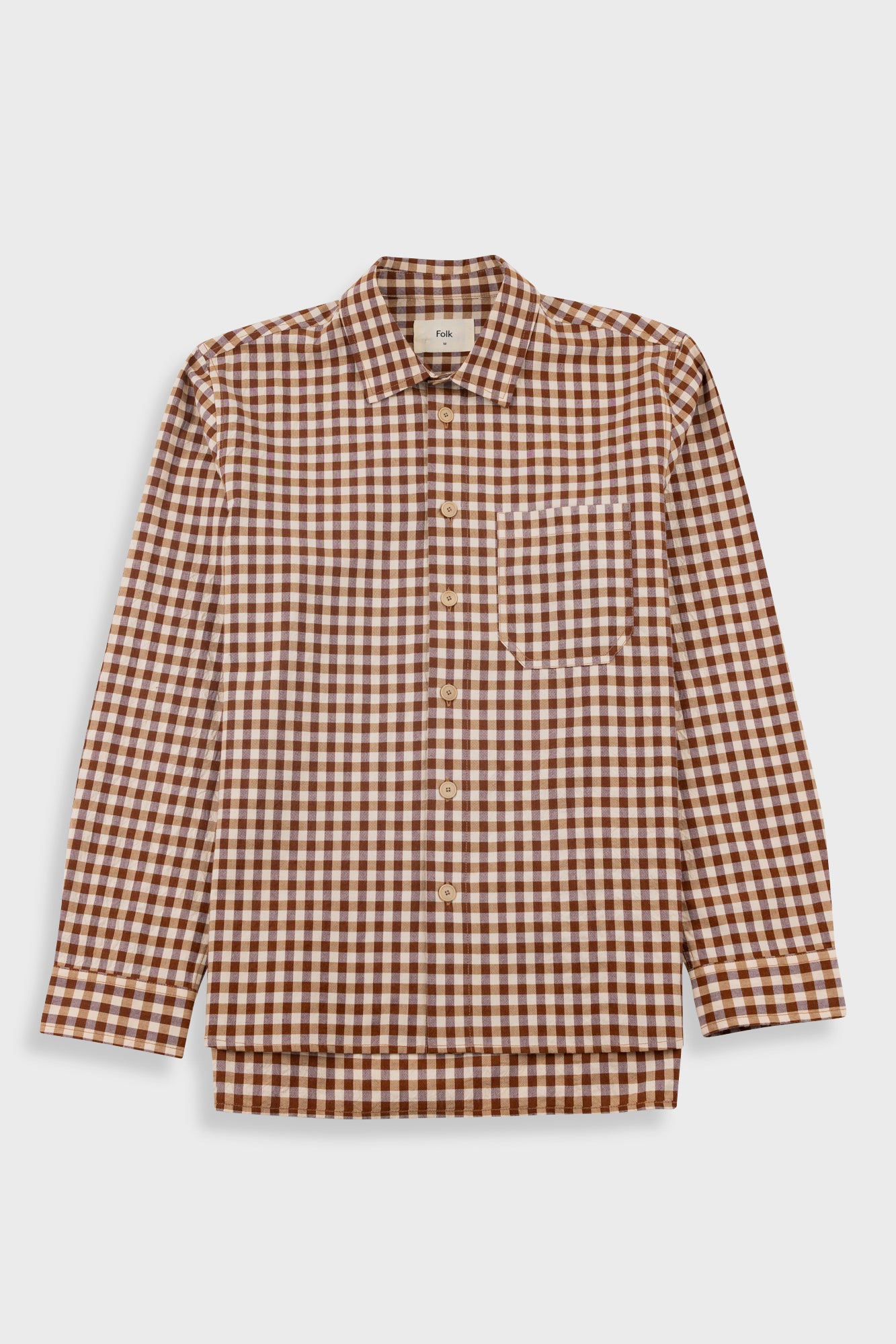 A long-sleeve button-up shirt with a brown and beige gingham check pattern, featuring a single chest pocket and a pointed collar, shown against a light gray background.
