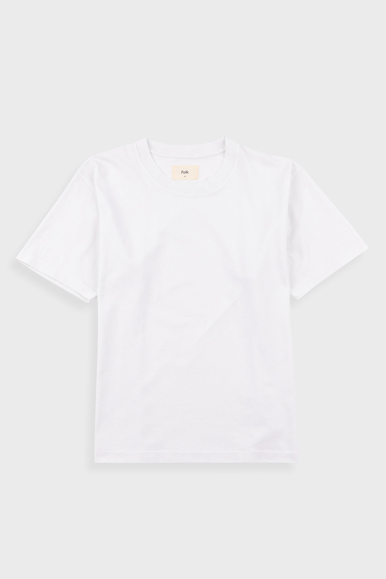 A plain white short-sleeve crewneck t-shirt laid flat against a light gray background.