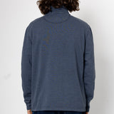 Person wearing a blue sweater against a white background