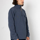 Man wearing a blue pullover with a zipper on a white background