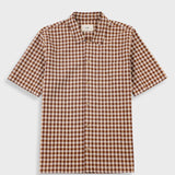 A short-sleeve button-up shirt with a brown and beige gingham check pattern, displayed flat against a light gray background.