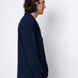 Man wearing a navy blue shirt against a white background