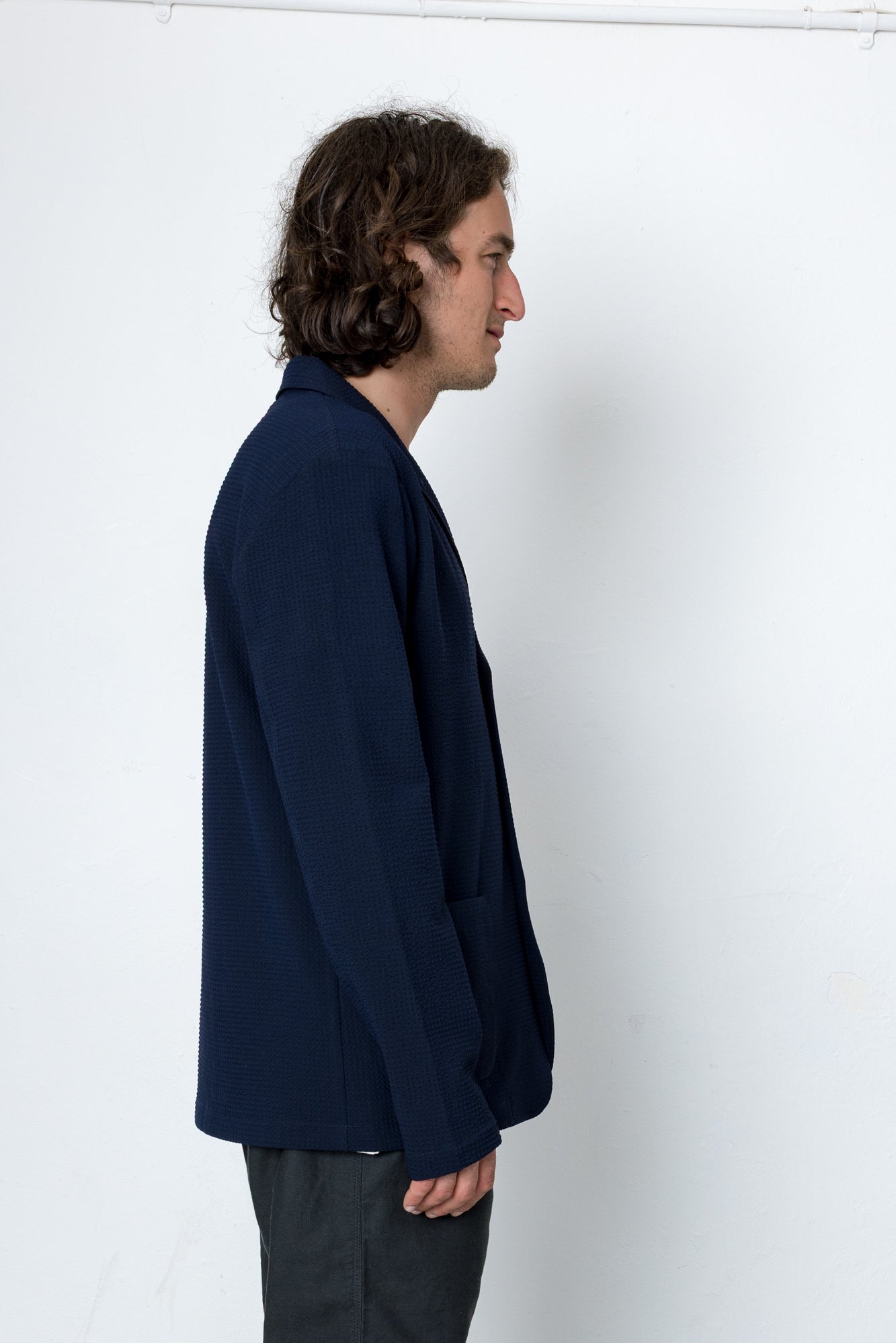 Man wearing a navy blue shirt against a white background