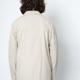 Back of a man wearing a striped beige blazer