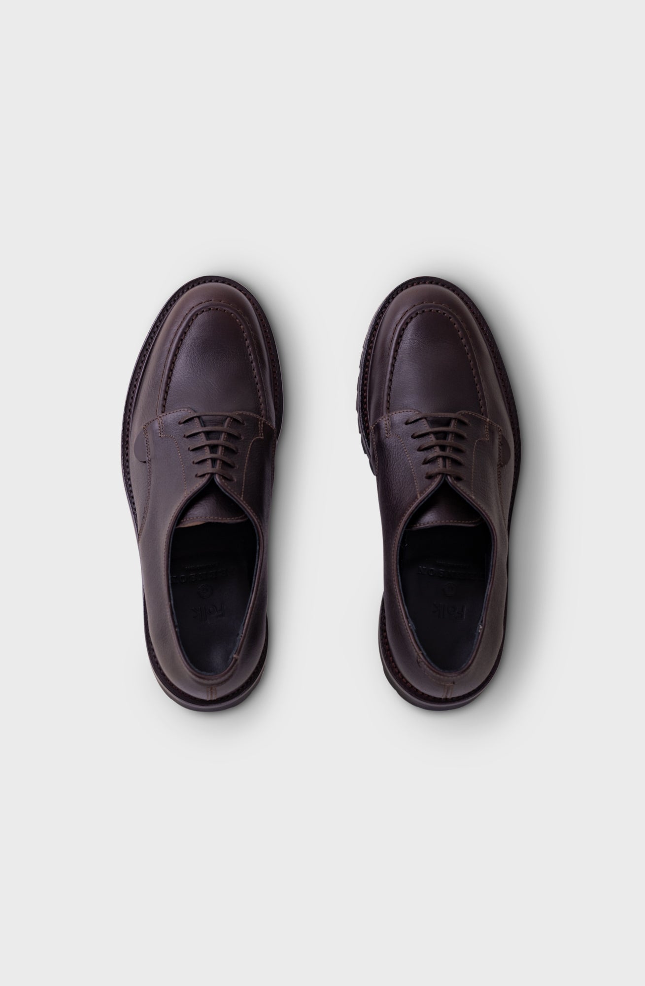 A pair of dark brown leather lace-up shoes shown from a top-down view on a light gray background.