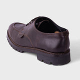 A dark brown leather lace-up shoe shown from a rear three-quarter angle against a light gray background.