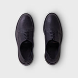 A pair of dark navy blue leather oxford shoes shown from a top-down view on a light gray background.