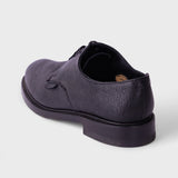 A dark purple textured leather lace-up shoe shown from a rear three-quarter angle on a light gray background.