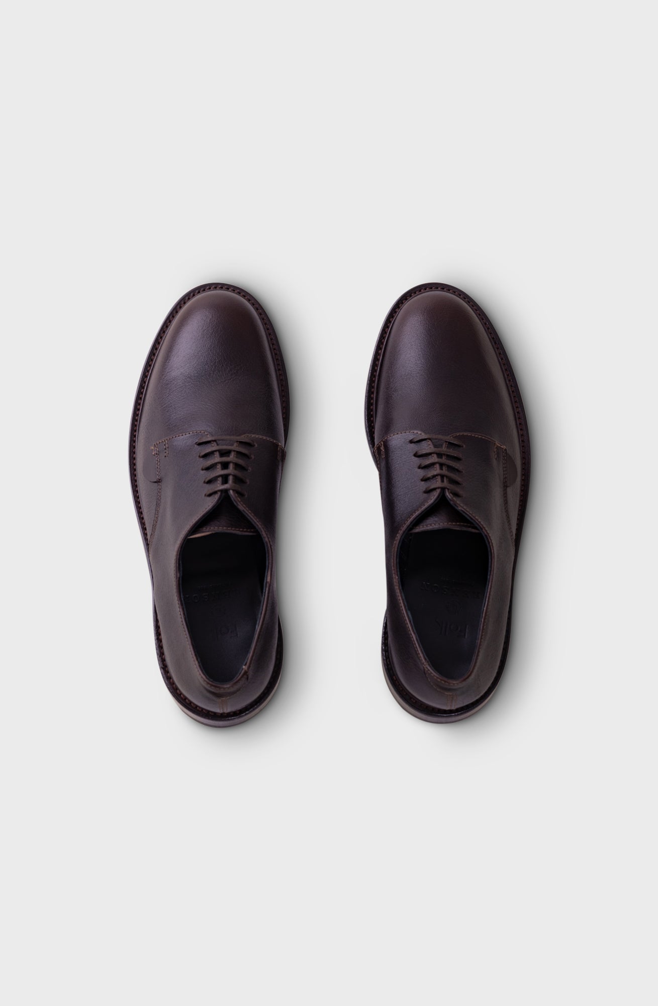 A pair of dark brown leather lace-up oxford shoes shown from a top-down view on a light gray background.